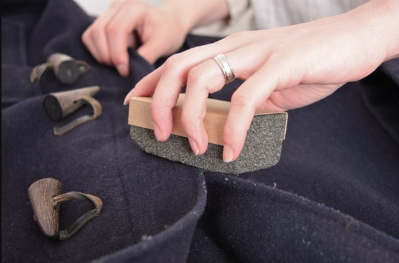 Use a pumice stone - How to Remove Lint From Clothes